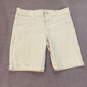 White knee length jean shorts.